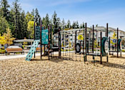Thumbnail 11 of 18 - A playground with a slide and climbing frame at View by Vintage Apartments, Bonney Lake, WA