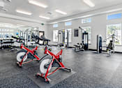 Thumbnail 8 of 18 - A gym with a row of red weight machines at View by Vintage Apartments, Bonney Lake, 98391