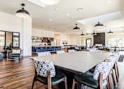 Thumbnail 2 of 18 - A large dining room with a long table and chairs at View by Vintage Apartments, Bonney Lake, WA 98391