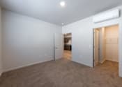 Thumbnail 9 of 14 - a bedroom with a closet and a door to a bathroom at Springview by Vintage, Reno, 89512
