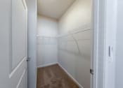 Thumbnail 10 of 14 - a spacious closet in a bedroom with white walls and a white door at Springview by Vintage, Reno, NV, 89512