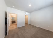 Thumbnail 11 of 14 - a living room with white walls and a door to a bathroom at Springview by Vintage, Reno, NV, 89512