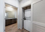 Thumbnail 12 of 14 - a laundry room with a washer and dryer inside of a door at Springview by Vintage, Nevada
