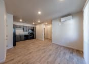 Thumbnail 14 of 14 - an empty living room and kitchen with a wood floor at Springview by Vintage, Reno, 89512