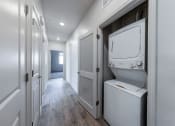 Thumbnail 5 of 14 - a laundry room with a washer and dryer and a door to a closet at Springview by Vintage, Reno, NV