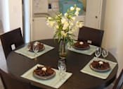 Thumbnail 17 of 21 - Dining table with washer and dryer at Carolina Club Apartments, Daytona Beach