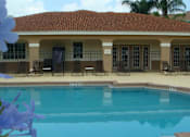 Thumbnail 8 of 15 - Pool and lounge chairs at Hawk's Landing Apartments, Florida