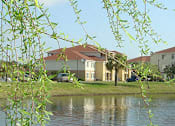 Thumbnail 7 of 14 - view to buildings from across the lake at Hunters Run, Florida, 32068
