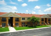 Thumbnail 11 of 14 - Marbrisa Apartments community exterior and parking area at Marbrisa Apartments, Miami Gardens, 33014