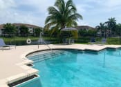Thumbnail 3 of 27 - Pool and lounge chairs at Tuscany Place Apartments, Homestead , FL