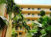 Thumbnail 12 of 14 - community exterior with palm trees and walk ways at Villa Hermosa, Miami, FL