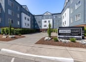 Thumbnail 1 of 27 - a building with a sign that reads western court apartment homes