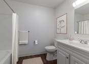 Thumbnail 6 of 27 - a bathroom with a toilet sink and shower and a mirror