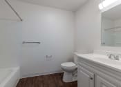 Thumbnail 10 of 27 - a bathroom with a toilet and a sink and a mirror