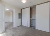 Thumbnail 16 of 27 - a bedroom with a closet and a laundry room