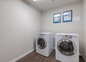 Thumbnail 20 of 27 - a laundry room with a washing machine and a dryer