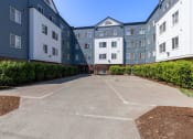 Thumbnail 27 of 27 - an empty parking lot in front of an apartment building