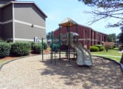 Thumbnail 14 of 52 - a playground with a slide in front of a building at Fort Vancouver Terrace, Vancouver