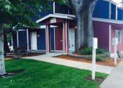 Thumbnail 20 of 52 - a sidewalk in front of a house with a tree in the yard at Fort Vancouver Terrace, Vancouver, WA, 98661