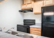 Thumbnail 29 of 52 - a kitchen with a sink stove and refrigerator at Fort Vancouver Terrace, Vancouver, 98661