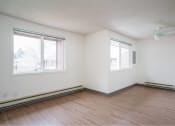 Thumbnail 37 of 52 - an empty room with wood floors and two windows at Fort Vancouver Terrace, Vancouver, WA