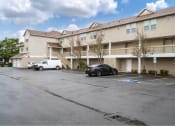 Thumbnail 3 of 50 - an empty parking lot in front of an apartment building at Quail Run Apartments, Vancouver, WA 98684