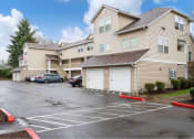 Thumbnail 4 of 50 - an empty parking lot in front of an apartment building at Quail Run Apartments, Vancouver, 98684