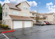 Thumbnail 5 of 50 - a row of houses with cars parked in a parking lot at Quail Run Apartments, Vancouver