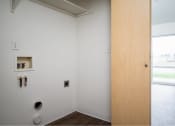 Thumbnail 13 of 50 - an empty room with a wooden door and a window at Quail Run Apartments, Vancouver, 98684
