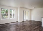 Thumbnail 15 of 50 - an empty living room with white walls and wood floors at Quail Run Apartments, Washington 98684