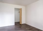 Thumbnail 21 of 50 - an empty room with a door to a closet at Quail Run Apartments, Washington 98684