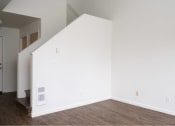 Thumbnail 26 of 50 - an empty room with white walls and a wood floor at Quail Run Apartments, Vancouver, WA 98684
