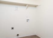 Thumbnail 29 of 50 - an empty room with a white wall and a pipe at Quail Run Apartments, Vancouver, WA