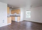 Thumbnail 30 of 50 - an empty living room and kitchen with wood floors at Quail Run Apartments, Vancouver, WA