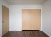 Thumbnail 35 of 50 - an empty room with white walls and wooden floors at Quail Run Apartments, Washington 98684