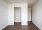 Thumbnail 37 of 50 - an empty living room with white walls and wood floors at Quail Run Apartments, Vancouver, 98684