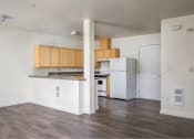 Thumbnail 40 of 50 - an empty kitchen with a refrigerator and a sink at Quail Run Apartments, Vancouver, Washington