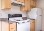 Thumbnail 41 of 50 - a kitchen with a stove and a refrigerator at Quail Run Apartments, Vancouver