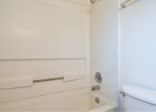 Thumbnail 44 of 50 - a white bathroom with a toilet and a bath tub at Quail Run Apartments, Vancouver, Washington