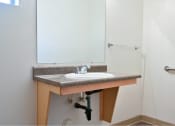 Thumbnail 47 of 50 - a bathroom with a sink and a mirror at Quail Run Apartments, WA