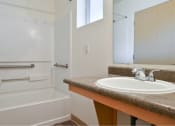 Thumbnail 49 of 50 - a bathroom with a sink and a tub and a mirror at Quail Run Apartments, Vancouver, WA