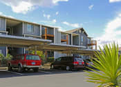 Thumbnail 3 of 46 - two cars parked in a parking lot in front of a building at Troutdale Terrace, Troutdale, OR