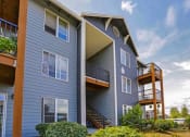 Thumbnail 9 of 46 - a blue house with a deck and a blue sky at Troutdale Terrace, Oregon