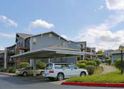 Thumbnail 10 of 46 - a parking lot with cars in front of a building at Troutdale Terrace, Oregon 97060
