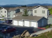 Thumbnail 11 of 46 - a row of houses with cars parked in a parking lot at Troutdale Terrace, Troutdale, Oregon