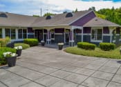 Thumbnail 15 of 46 - the front of a house with a driveway and flower pots at Troutdale Terrace, Troutdale,  97060