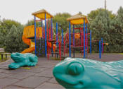 Thumbnail 19 of 46 - a children playground with two swings and a slide at Troutdale Terrace, Troutdale, OR