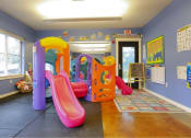 Thumbnail 21 of 46 - a children play room with slides and toys at Troutdale Terrace, Troutdale