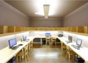 Thumbnail 23 of 46 - a room with a bunch of desks with laptops at Troutdale Terrace, Troutdale