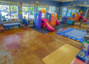 Thumbnail 25 of 46 - a children play room with slides and other toys at Troutdale Terrace, Oregon 97060